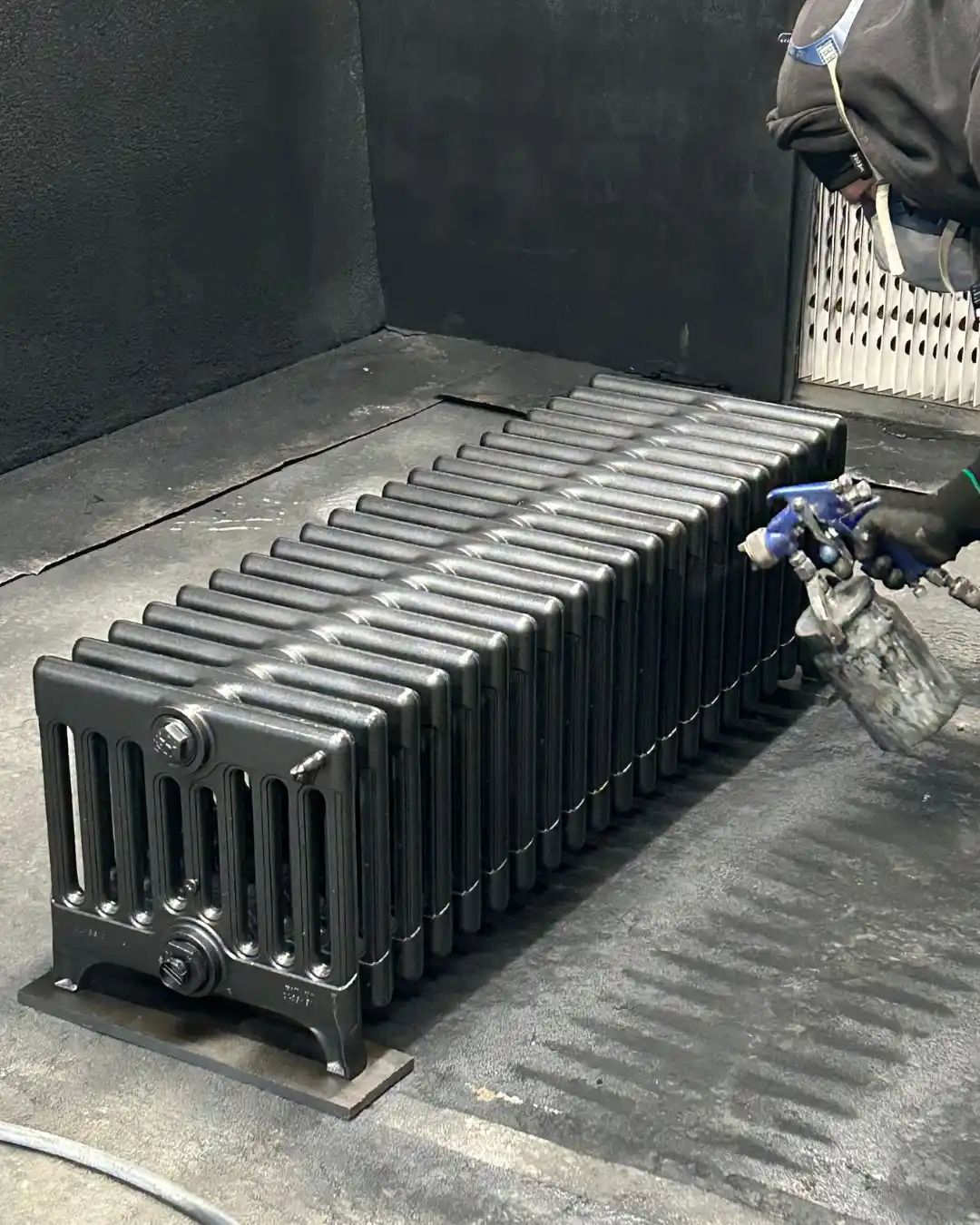 Restored cast iron radiator being hand-finished in the Radrestore workshop